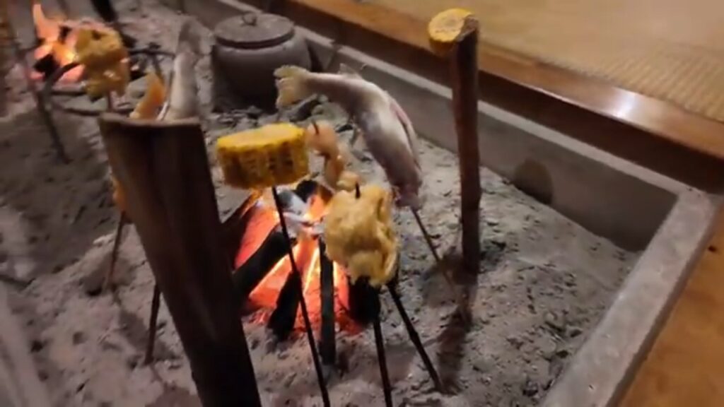 民宿やま久の囲炉裏で焼かれる串料理